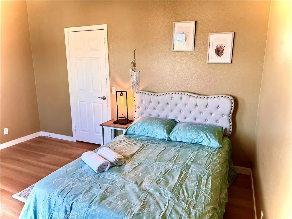 6805 Edinburgh Road Eastvale, CA 92880 - Photo 17 of 47 a bedroom with a bed and a painting on the wall