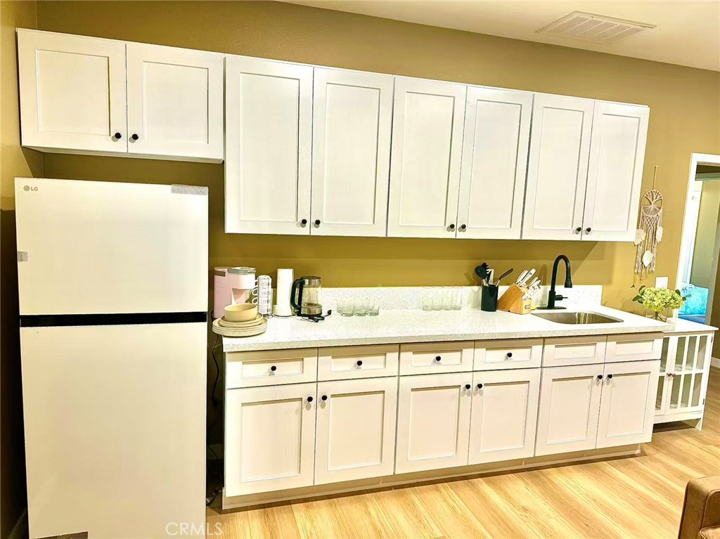 6805 Edinburgh Road Eastvale, CA 92880 - Photo 18 of 47 a white refrigerator freezer sitting inside of a kitchen