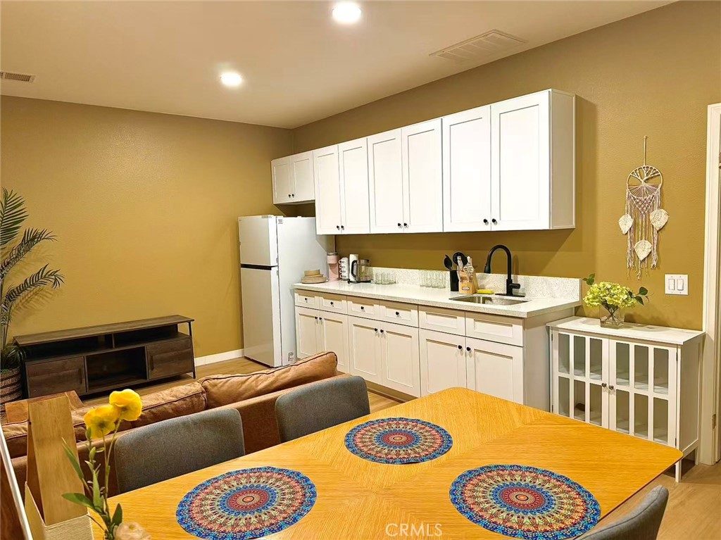 6805 Edinburgh Road Eastvale, CA 92880 - Photo 20 of 47 a kitchen with a sink appliances and cabinets