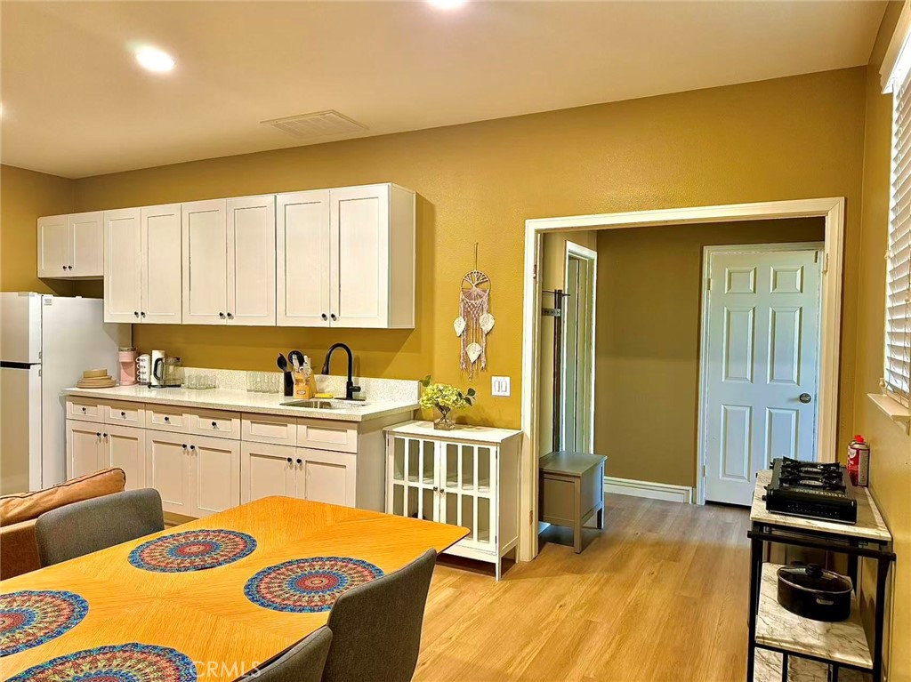 6805 Edinburgh Road Eastvale, CA 92880 - Photo 21 of 47 a kitchen with a sink stove and cabinets