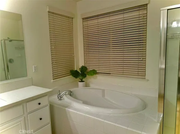 a spacious bathroom with a double vanity sink mirror and shower