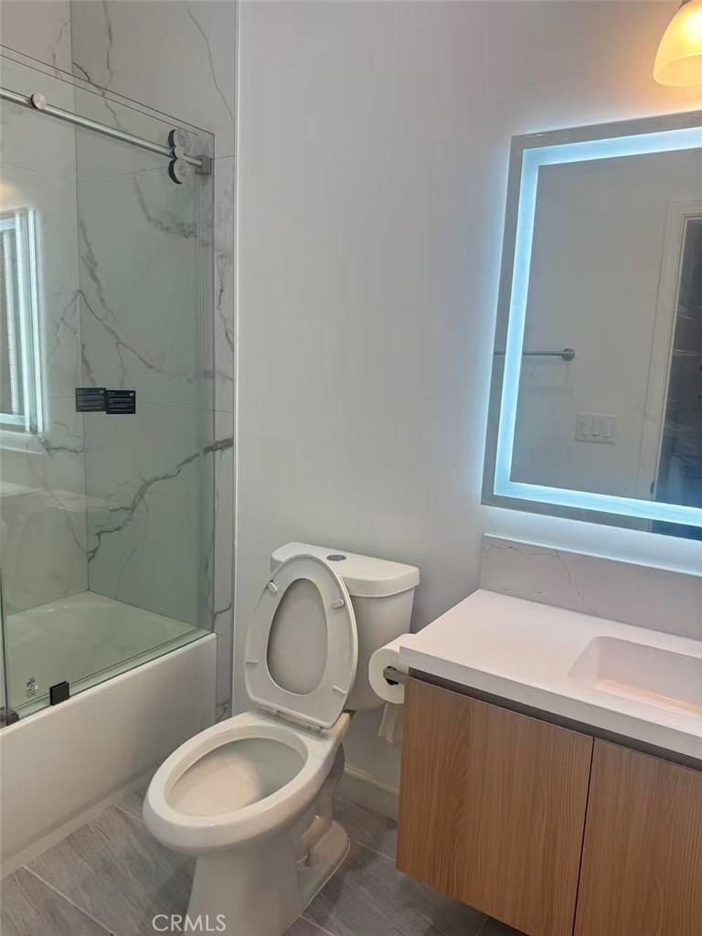 6805 Edinburgh Road Eastvale, CA 92880 - Photo 28 of 47 a bathroom with a sink a toilet and shower