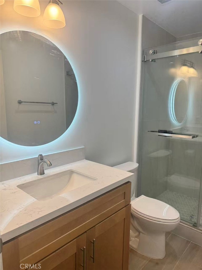 6805 Edinburgh Road Eastvale, CA 92880 - Photo 31 of 47 a bathroom with a sink and a mirror