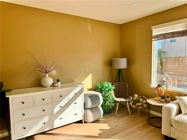 a bedroom with furniture and a large window