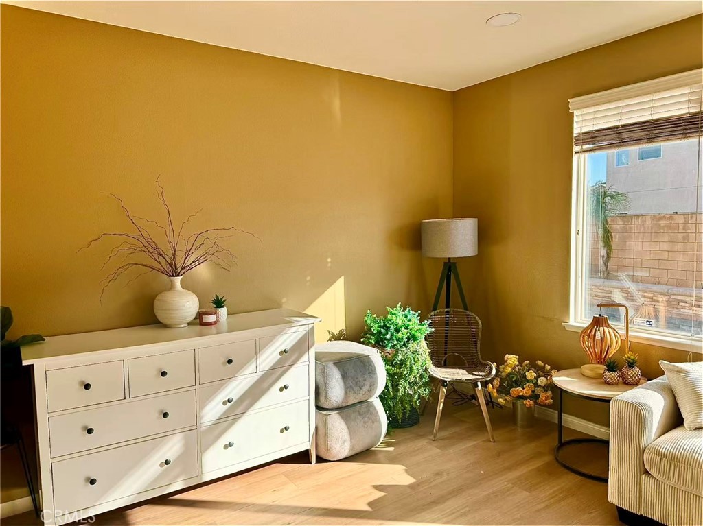 6805 Edinburgh Road Eastvale, CA 92880 - Photo 35 of 47 a living room with furniture and a table