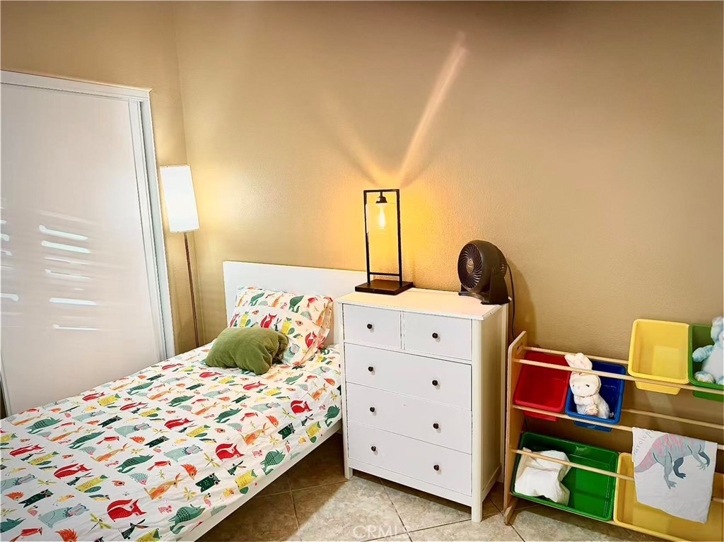 6805 Edinburgh Road Eastvale, CA 92880 - Photo 37 of 47 a bedroom with a bed and a dresser