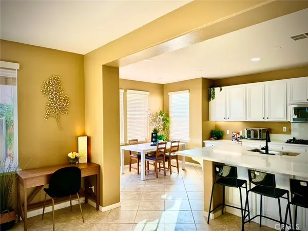 a kitchen with a sink appliances and a large window