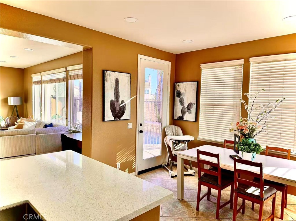 6805 Edinburgh Road Eastvale, CA 92880 - Photo 41 of 47 a living room with furniture and large windows