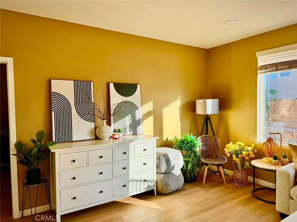 6805 Edinburgh Road Eastvale, CA 92880 - Photo 42 of 47 a spacious bedroom with a bed chair and mirror on the wall