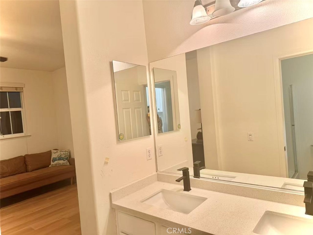 6805 Edinburgh Road Eastvale, CA 92880 - Photo 10 of 47 a bathroom with a sink and a mirror