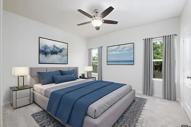 a bedroom with a large bed and a chandelier