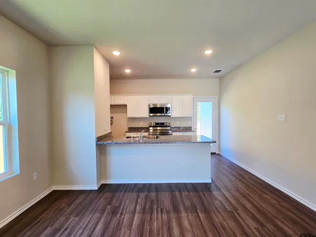 a view of kitchen with sink microwave and stove