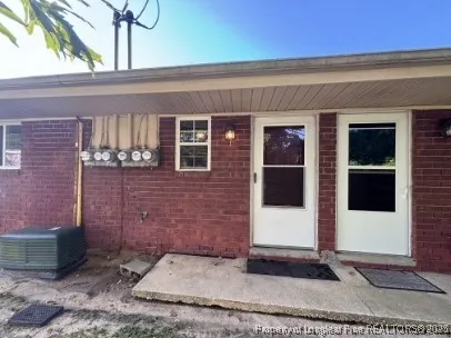 a view of a brick house with large windows
