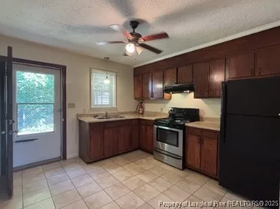 a kitchen with stainless steel appliances granite countertop a refrigerator oven a sink dishwasher and a refrigerator