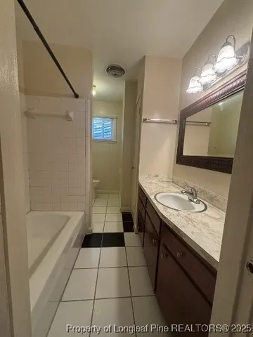 a bathroom with a sink a toilet a mirror and bathtub