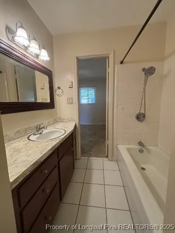 a spacious bathroom with a granite countertop sink a toilet a mirror and shower
