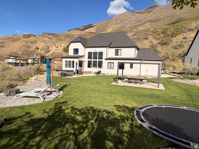 3626 Riverstone Road Mapleton, UT 84664 - Photo 53 of 58 Back of house featuring a patio, an outdoor fire pit, a shingled roof, and a mountain view