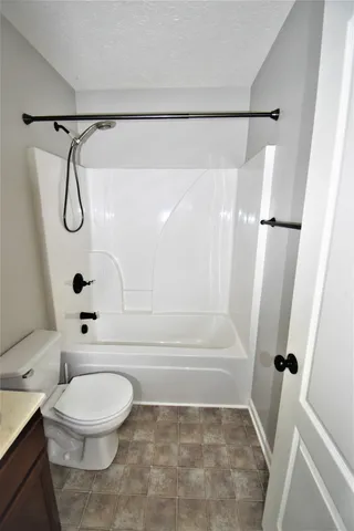 a bathroom with a sink mirror vanity and toilet