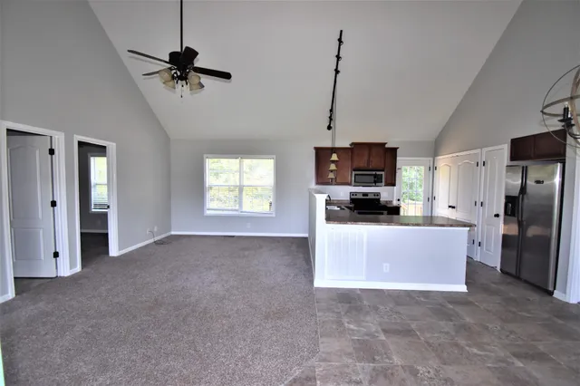 a view of a kitchen with a stove a microwave and a window