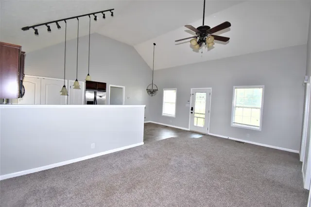 a view of a livingroom with a ceiling fan and window
