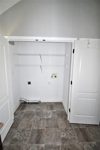 an empty room with ceiling fan and window