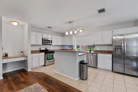 a kitchen with a sink microwave and refrigerator