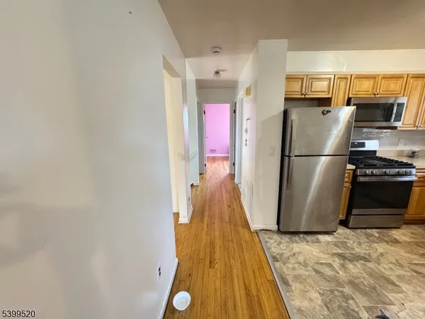 a view of a kitchen with a refrigerator