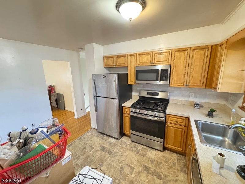 910 Randolph Avenue Rahway, NJ 07065 - Photo 2 of 14 a kitchen with stainless steel appliances granite countertop a sink stove and refrigerator