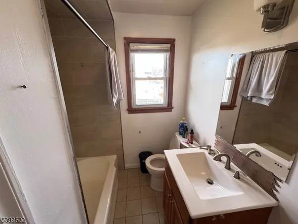 a bathroom with a sink a toilet and tub