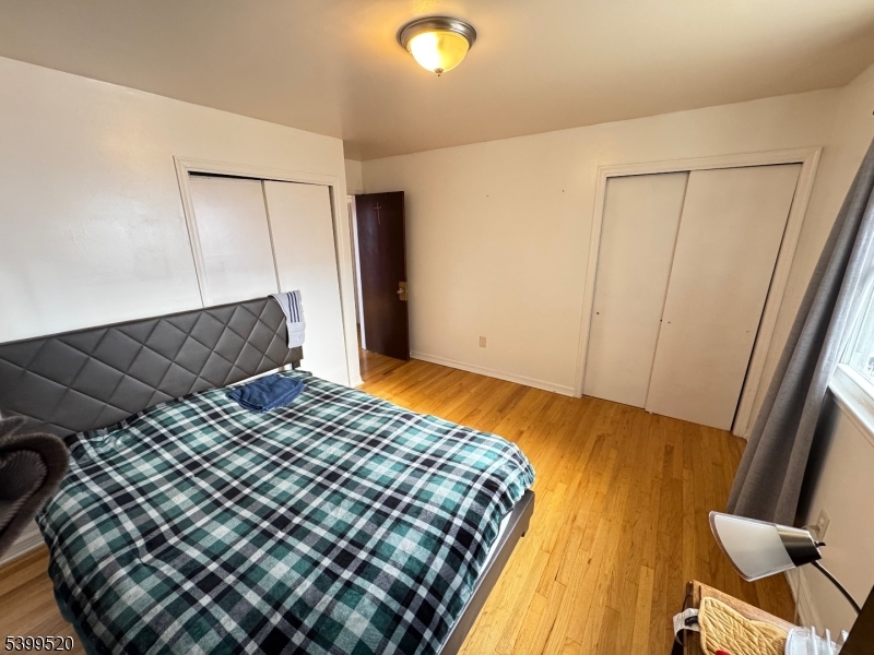 910 Randolph Avenue Rahway, NJ 07065 - Photo 8 of 14 a bedroom with a bed and wooden floor
