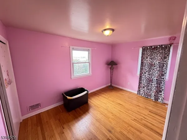 a view of a livingroom with a chair and a potted plant