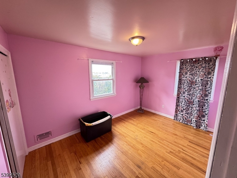 910 Randolph Avenue Rahway, NJ 07065 - Photo 9 of 14 a view of a livingroom with a chair and a potted plant