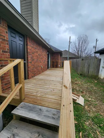 a view of backyard with wooden fence