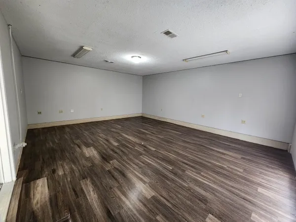 an empty room with wooden floor