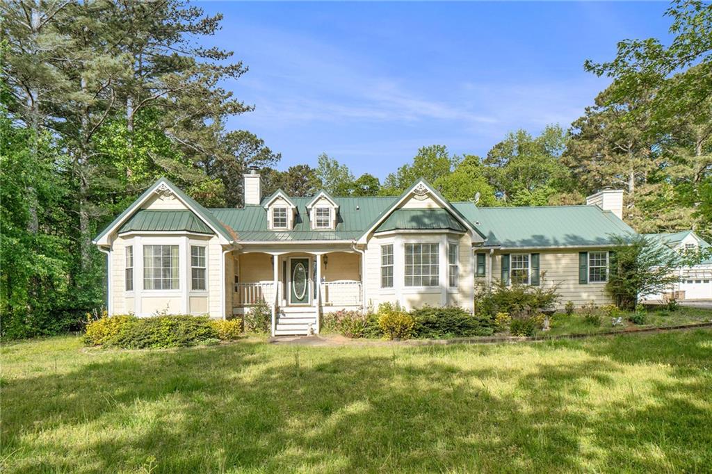 a front view of a house with a garden