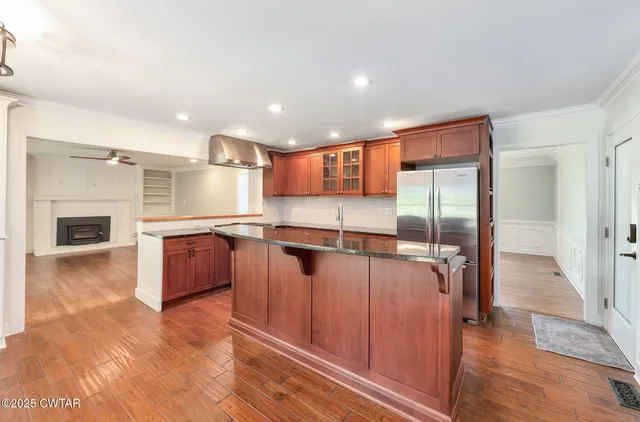 a view of a kitchen with a sink and a refrigerator