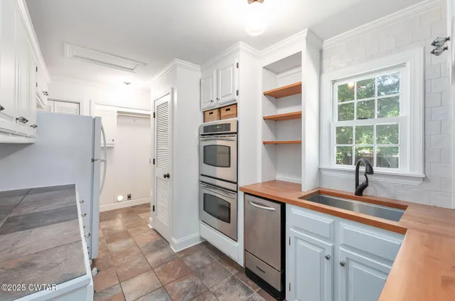 a kitchen with stainless steel appliances a refrigerator and a sink