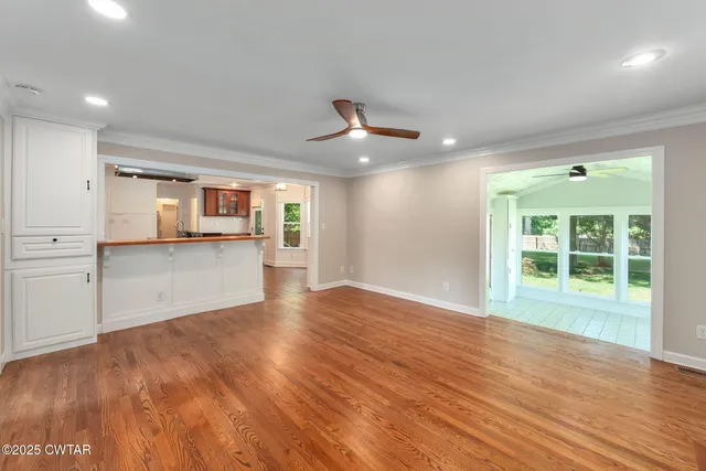 a view of a kitchen with wooden floor and a kitchen