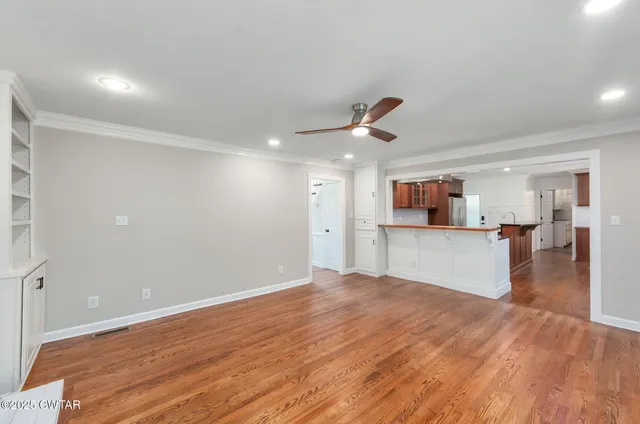 a view of a kitchen with wooden floor and a kitchen