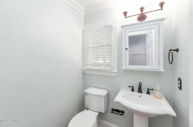 a bathroom with a sink a mirror and a toilet