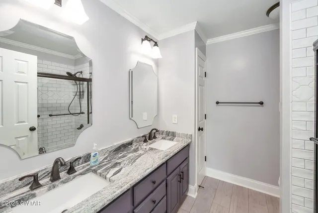 a bathroom with a granite countertop sink mirror and double