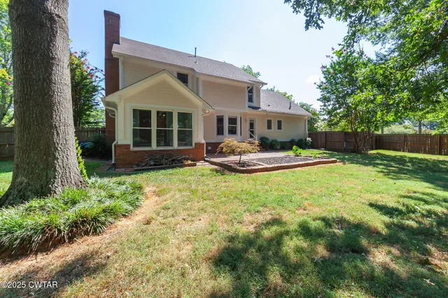 a front view of a house with a yard table and chairs