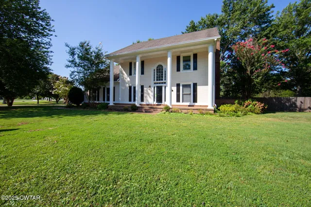 a front view of house with yard and green space
