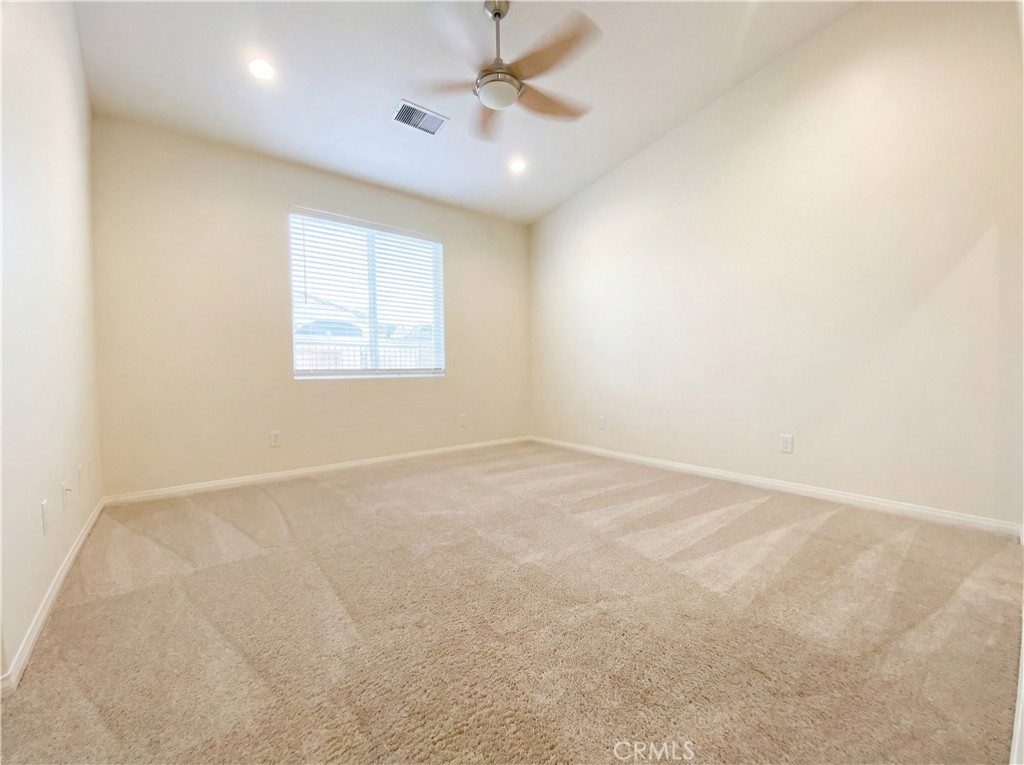 6057 Buena Suerte Road Yucca Valley, CA 92284 - Photo 8 of 48 an empty room with windows and fan