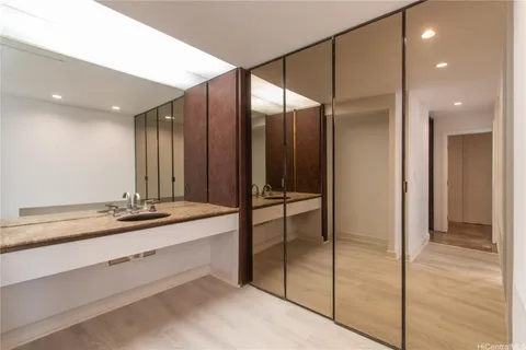 a bathroom with a double vanity sink and a mirror