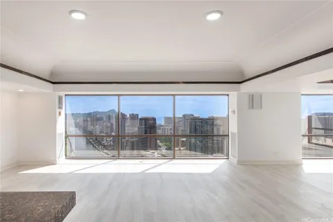 an empty room with a glass door and shower