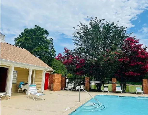 a swimming pool with outdoor seating and yard