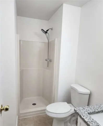 a white toilet and shower