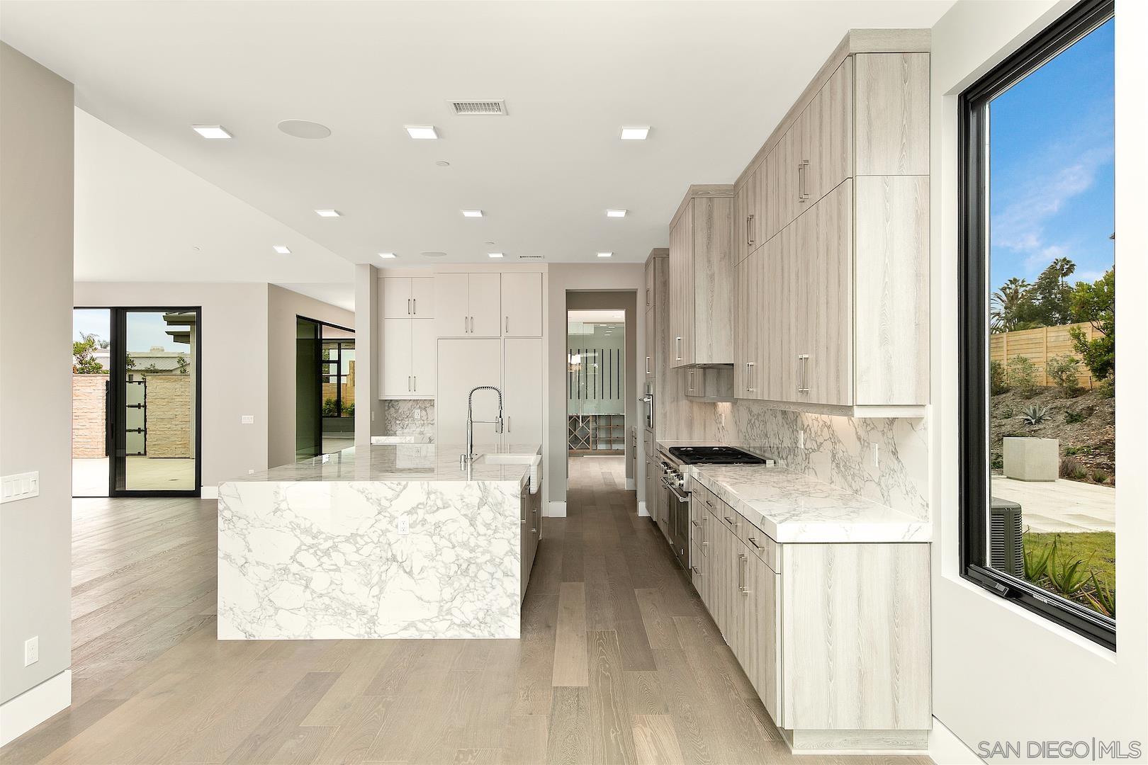 1817 Gwynn Drive Cardiff, CA 92007 - Photo 13 of 50 a large kitchen with stainless steel appliances kitchen island granite countertop a large counter top and a stove