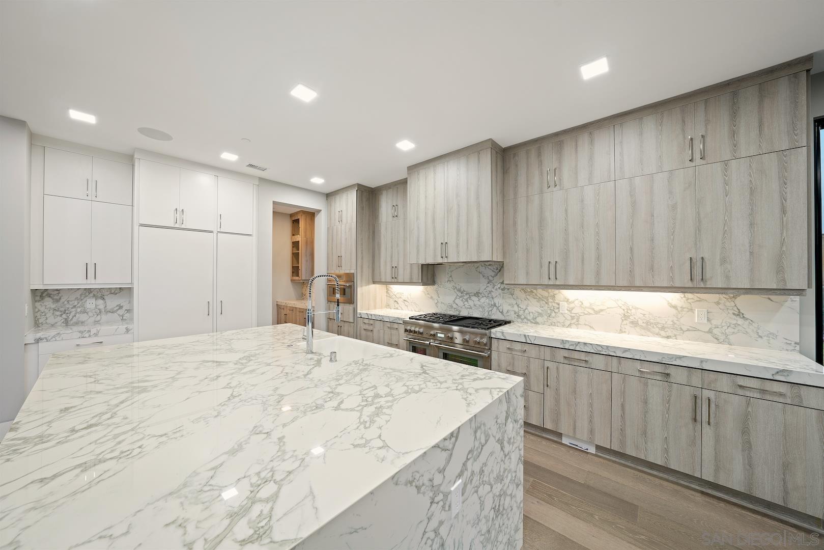 1817 Gwynn Drive Cardiff, CA 92007 - Photo 14 of 50 a large kitchen with kitchen island a sink stainless steel appliances and cabinets